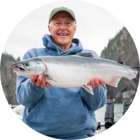 Man holding salmon in boat